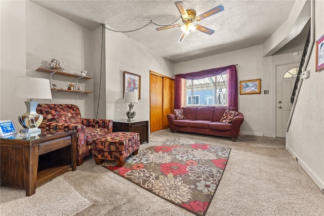 carpeted living room with ceiling fan and a textured ceiling