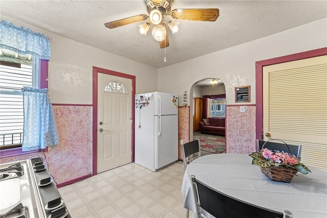 interior space featuring ceiling fan and a textured ceiling