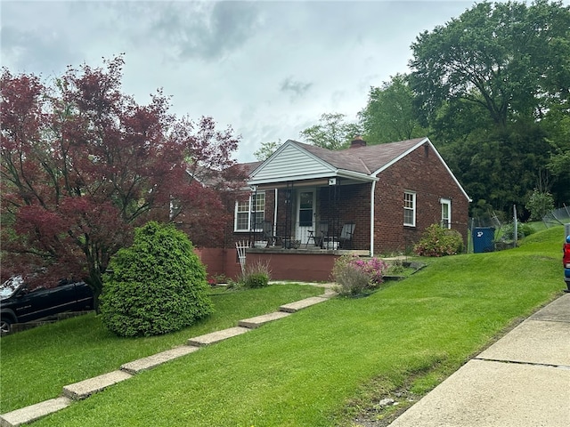 view of front of home featuring a porch and a front lawn