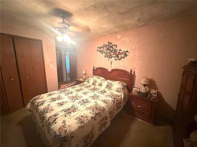 carpeted bedroom with a closet and ceiling fan