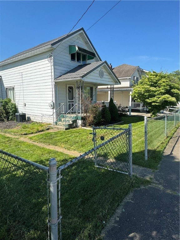 view of front of home with a front lawn and central AC unit