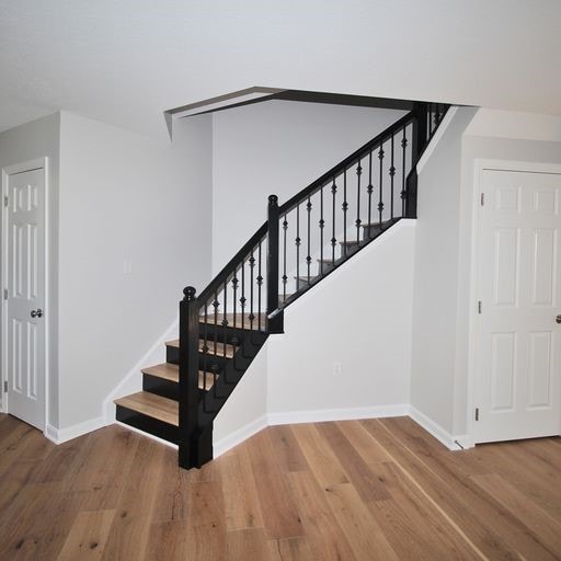 stairway featuring hardwood / wood-style floors