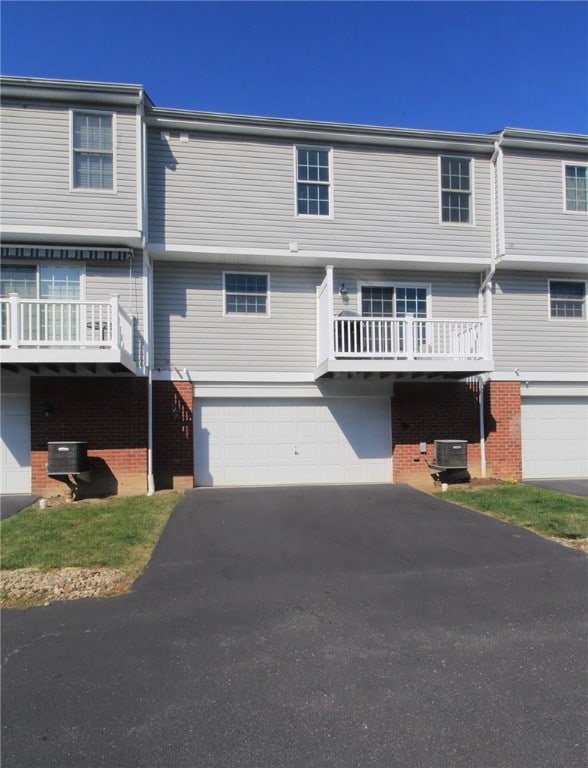 view of front of house featuring a garage and central air condition unit