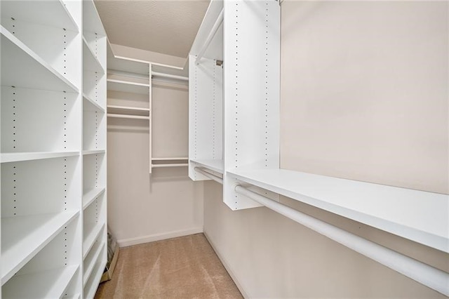 walk in closet with carpet