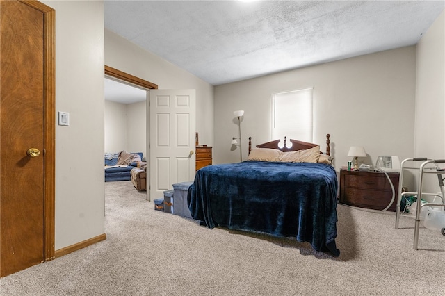 bedroom with a textured ceiling and carpet floors