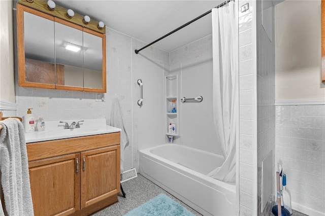 bathroom featuring shower / bath combo, vanity, and tile walls