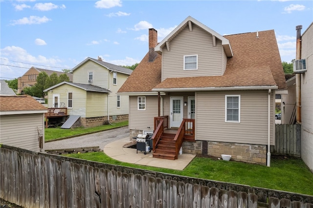 back of property featuring a yard and a patio area