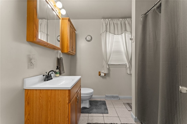 bathroom featuring tile floors, oversized vanity, and toilet