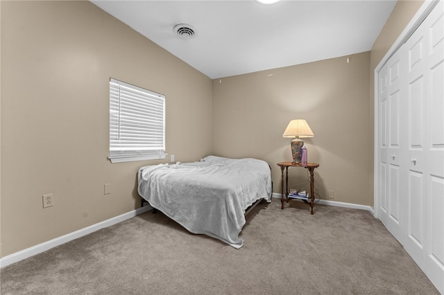 carpeted bedroom featuring a closet