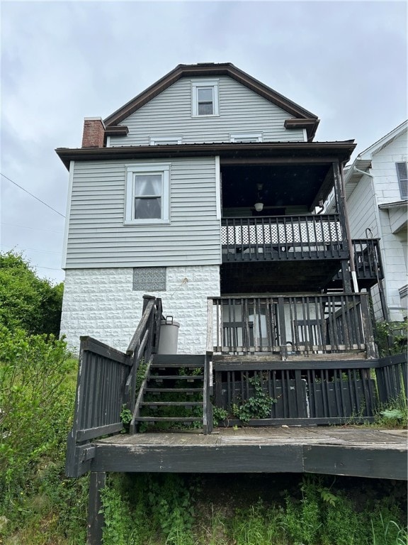 back of property featuring a wooden deck