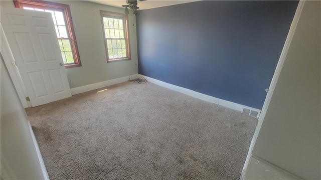 unfurnished room featuring carpet flooring