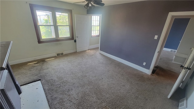 carpeted empty room with ceiling fan