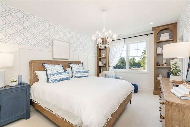 bedroom with a chandelier and light colored carpet