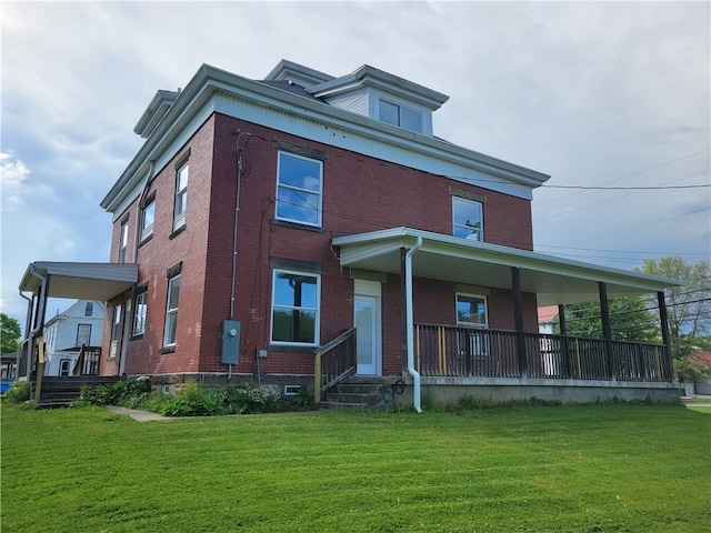 rear view of property with a lawn and a porch