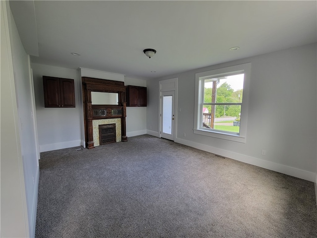 unfurnished living room with dark carpet