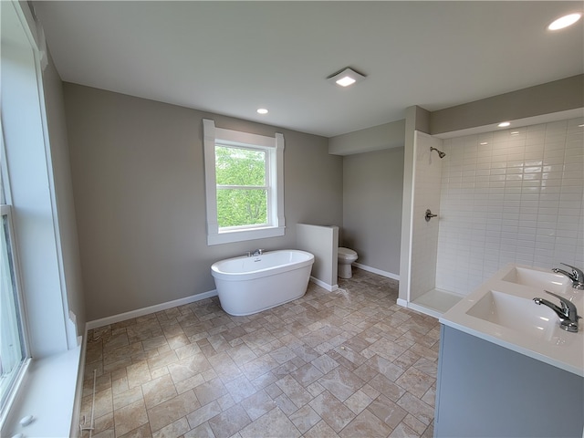 bathroom with tile floors, a tile shower, toilet, and dual sinks