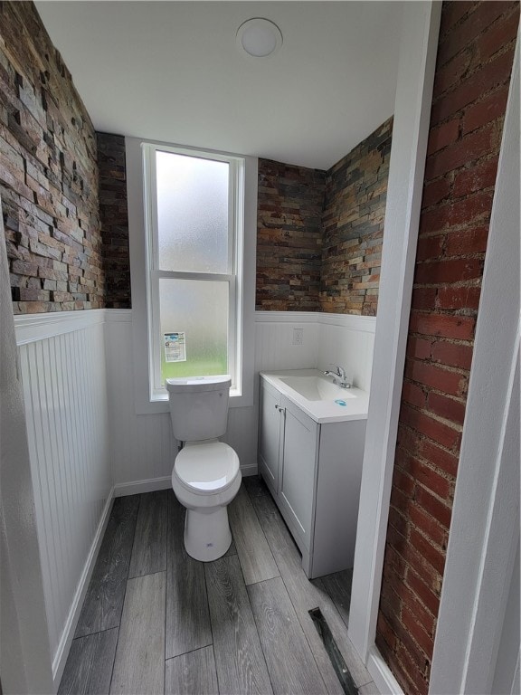 bathroom featuring hardwood / wood-style floors, toilet, and vanity