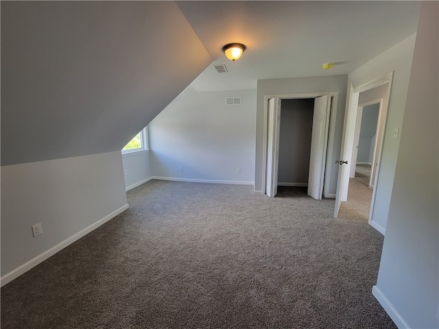 bonus room featuring carpet and vaulted ceiling