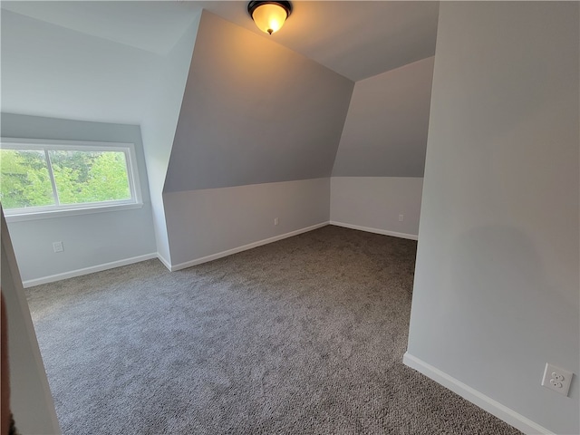 bonus room featuring lofted ceiling and carpet flooring