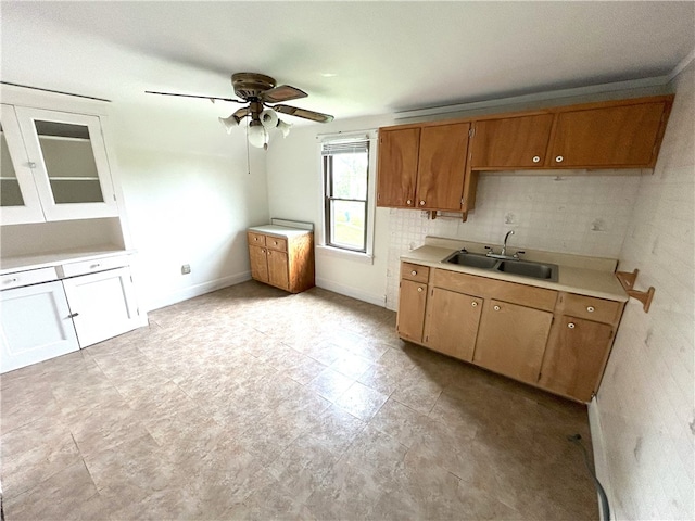 kitchen featuring sink, tasteful backsplash, ceiling fan, and light tile floors