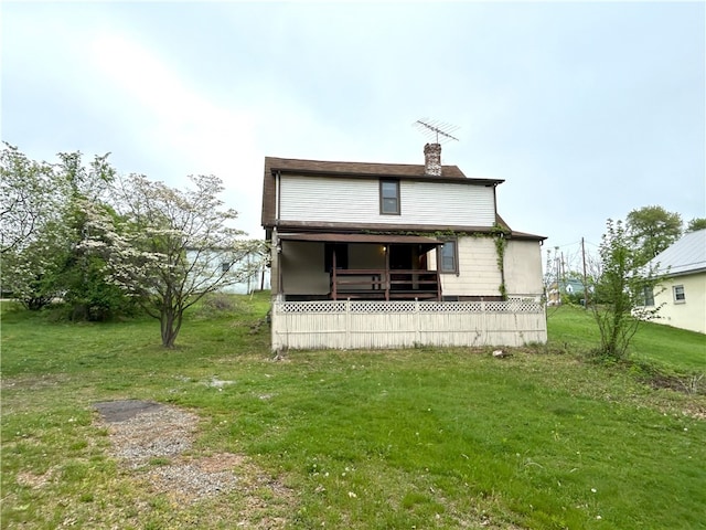 back of house with a lawn