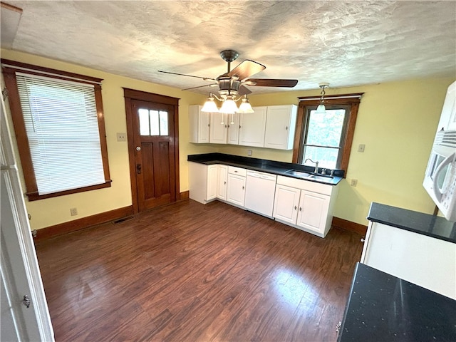 kitchen with dark wood-type flooring, white appliances, white cabinets, plenty of natural light, and ceiling fan