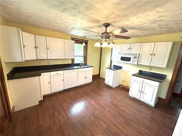 kitchen featuring white cabinetry, white appliances, and dark hardwood / wood-style floors