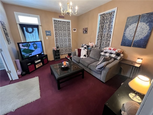 carpeted living room featuring an inviting chandelier