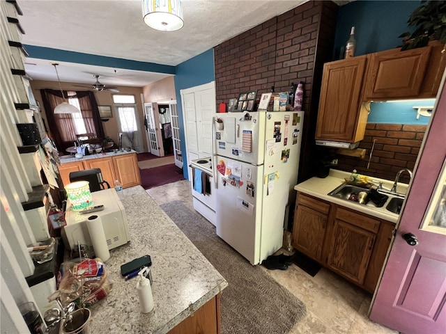 kitchen with ceiling fan, white appliances, decorative light fixtures, a textured ceiling, and brick wall