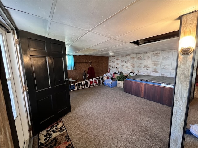 bar with carpet flooring and a drop ceiling