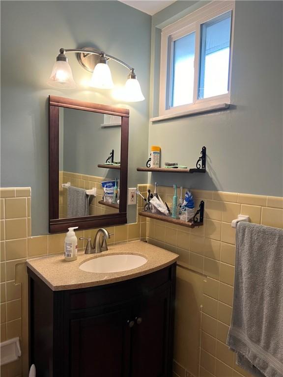 bathroom featuring tile walls, vanity, and tasteful backsplash