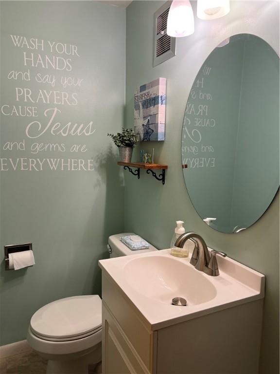 bathroom featuring toilet and vanity