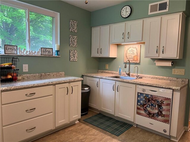 kitchen with sink, white cabinetry, white dishwasher, and light tile patterned floors