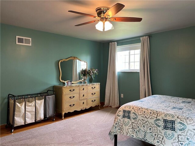 bedroom with ceiling fan and hardwood / wood-style floors