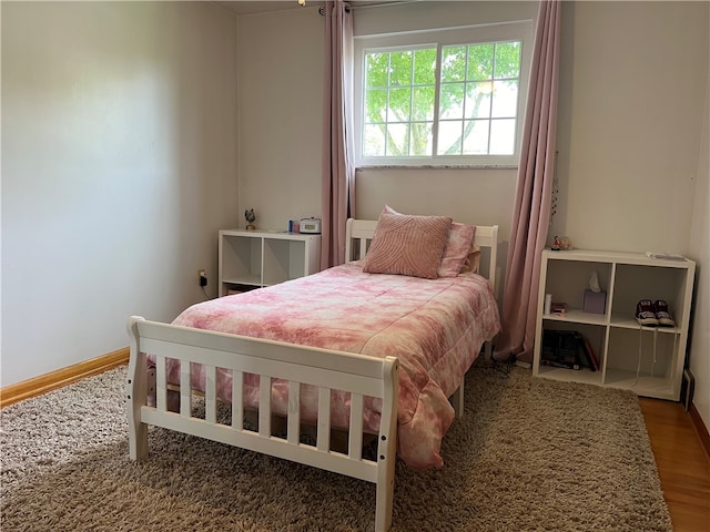 bedroom with hardwood / wood-style floors