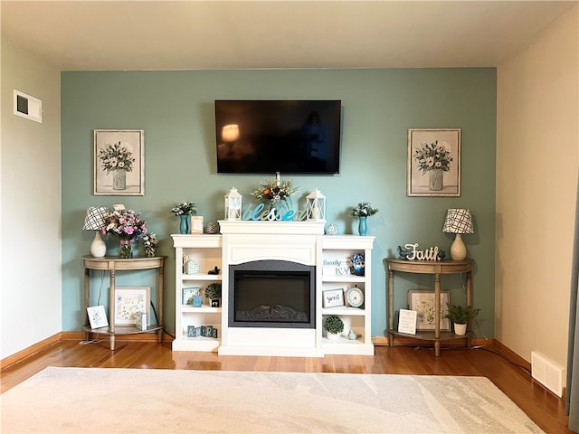 unfurnished living room with hardwood / wood-style flooring