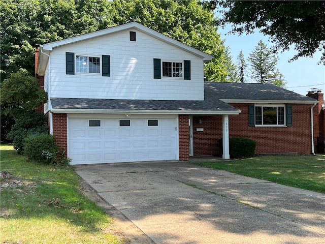 tri-level home with a garage and a front lawn