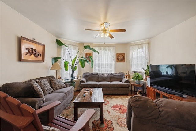 living room featuring hardwood / wood-style flooring and ceiling fan