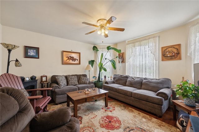 living room featuring ceiling fan and hardwood / wood-style floors