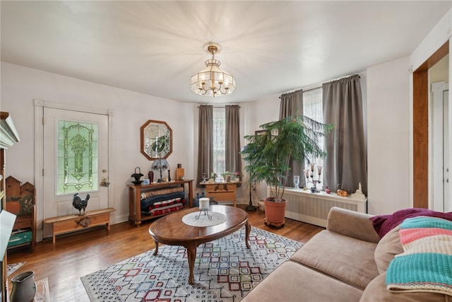 living room with a chandelier and hardwood / wood-style flooring