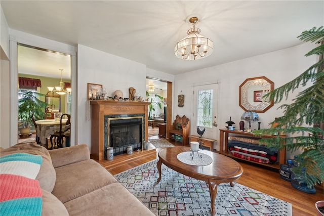 living room with a notable chandelier and hardwood / wood-style flooring