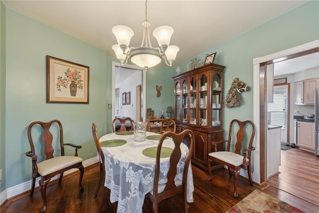 dining room featuring a chandelier and dark hardwood / wood-style flooring