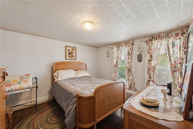 bedroom featuring hardwood / wood-style floors and a textured ceiling