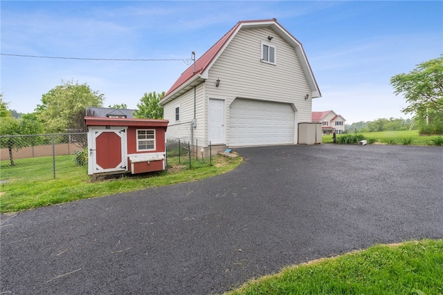 exterior space with a garage and an outdoor structure