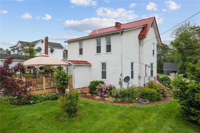 back of house with a yard and a deck