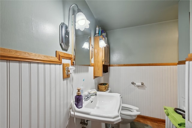 bathroom with sink, hardwood / wood-style flooring, and toilet