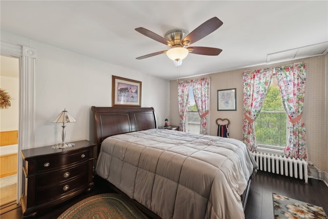 bedroom with wood-type flooring, radiator, and ceiling fan