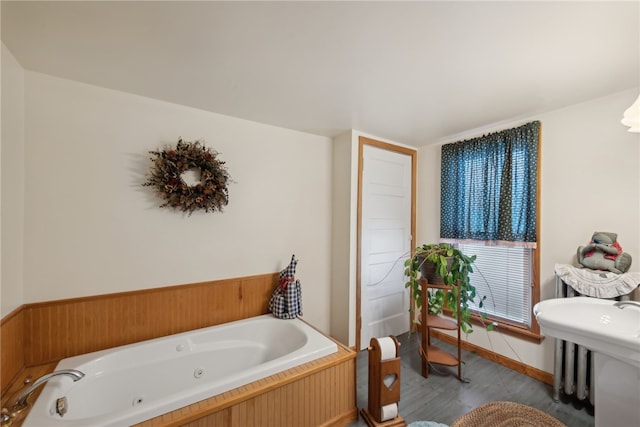 bathroom with a bathtub and radiator