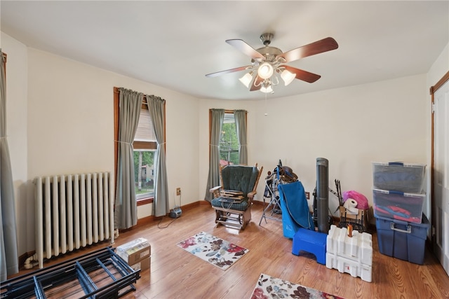 interior space featuring ceiling fan, hardwood / wood-style floors, and radiator