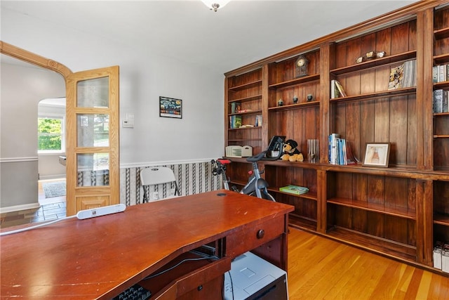 home office with light hardwood / wood-style floors